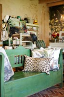 Patterned cushions on green bench
