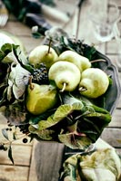 Pears and vegetables in metal bowl