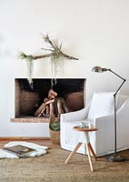 White armchair by fireplace