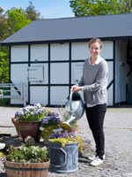 Woman watering pot plants