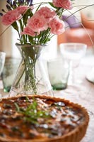 Vase of Carnation flowers on dining table