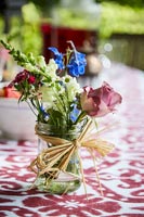 Jar of flowers on garden table