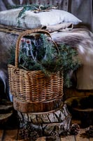 Bottles and conifer foliage in wicker basket
