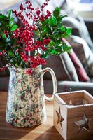 Vase of berries and Holly foliage