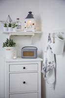Accessories on white chest of drawers