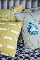 Patterned cushions on bed