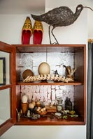 Open wooden display cabinet of objects