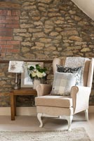 Seating area beside stone wall