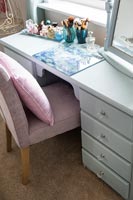 Painted wooden dressing table and chair in bedroom