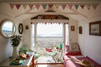 Interior of beach hut with view out to beach