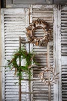 Decorative wreaths on wooden shutters