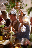 People enjoying eating at the decorated dining table 