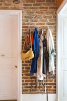 Clothes and bags hanging on wall hooks