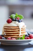 Stack of pancakes and fruit on a plate