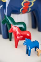 Detail of wooden model horses on table