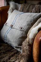 Detail of cushion on vintage leather armchair