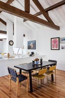 Dining table and chairs in open plan loft dining space