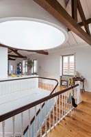 Classic wooden staircase balustrades in open plan loft space