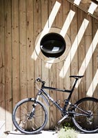 Bicycle outside modern wooden house