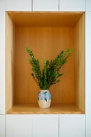 Foliage on display in recessed wall niche
