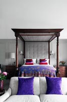Contemporary bedroom with classic four poster bed