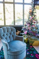 Modern living room decorated with a Christmas tree