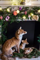 Detail of foxes in fireplace decorated for Christmas