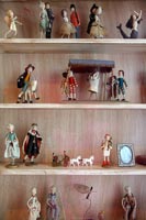 Miniatures on wooden shelves