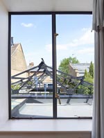 Bedroom window with view to metal courtyard roof