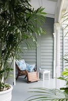 Garden chair on veranda of classic wooden house
