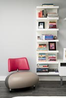 Detail of retro chair and bookshelves
