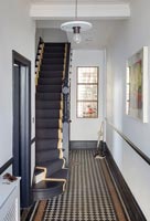 Tiled hallway with staircase