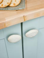 Detail of stone kitchen cupboard handles