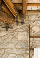 Detail of rustic stone wall and wooden beams