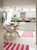 Striped rugs in rustic country kitchen