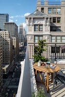 Round table on a balcony with views of New York City 