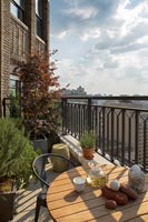Table on balcony with views of New York City 