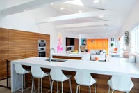 Modern white kitchen stools in open plan apartment 