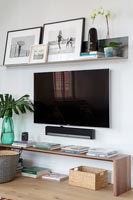 Large wall mounted flat screen television in contemporary living room