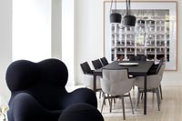 Modern black armchair in open plan living and dining room 