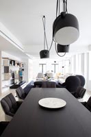 Black and white dining table in open plan apartment 