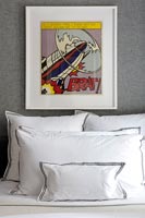 Modern bedroom with colourful artwork above bed 