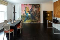 Eclectic dining room with large modern paintings 