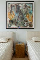 Twin beds with large modern painting 