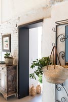 Basket with plant hanging in modern country hallway 