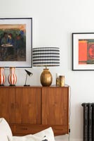 Lamps and vases on vintage wooden sideboard 