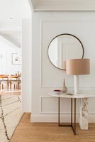 Marble console table lamp and mirror in hallway