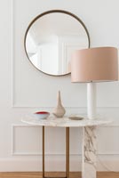Marble console table with lamp and mirror in hallway