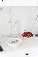 White kitchen unit with marble splashback