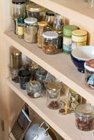 Kitchen shelves with jars of herbs and spices